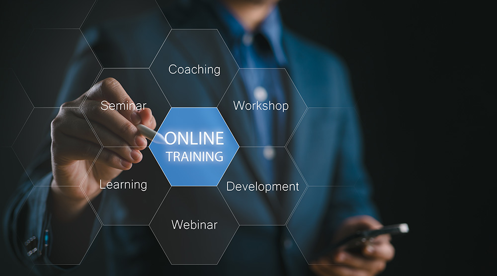 Person behind glass screen pointing to Online training hexagon..