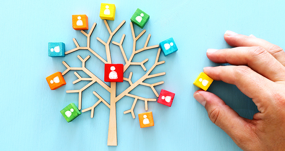 A wooden tree with people icons in the branches. .